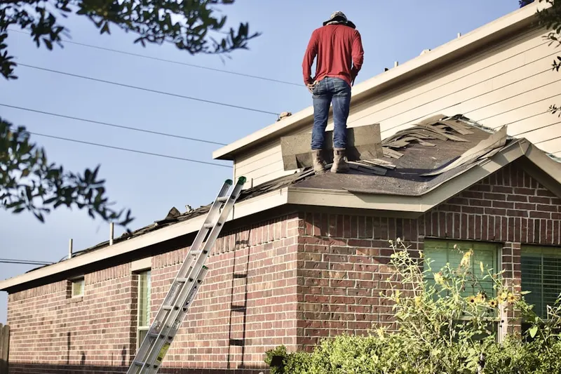 Professional roofer working on a residential roof in Croissant Park